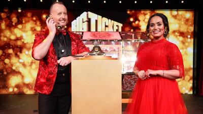 Presenters Richard Isaac and Bouchra deliver the good news to Mohammed Mishfak. Courtesy: Abu Dhabi Big Ticket