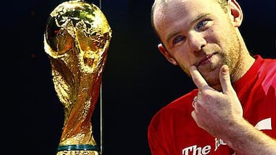 Rooney poses with the World Cup trophy at Earls Court in London on Thursday. The Manchester United striker will lead the line for Fabio Capello's England side in South Africa in June.