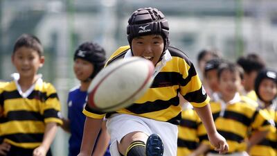 A member of Katsushika Rugby School kicks a ball during a skills session in Tokyo this month. Yuya Shino / Reuters