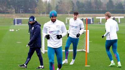 Kyle Walker, John Stones, and Kevn De Bruyne go through a drill during a Manchester City training session. PA