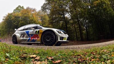 Finland's driver Jari-Matti Latvala and co-driver Miikka Anttila to victory in their Volkswagen Polo R at the Rally of France-Alsace, the 11th event of the 13-leg World Rally Championship, on October 5, 2014. AFP / PATRICK HERTZOG