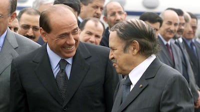 Former Algerian president Abdelaziz Bouteflika, right, welcomes Mr Berlusconi for a two-day visit aimed at boosting economic ties between the two countries, in June 2002. AFP