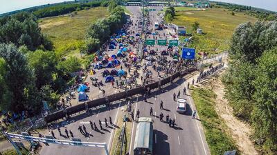 Migrants camping on the border between Hungary and Serbia near Roeszke. Istvan Ruzsa / AFP Photo