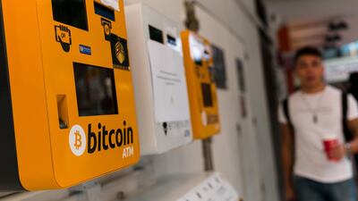 A man walks past Bitcoin ATMs in Wanchai, Hong Kong, this month. EPA