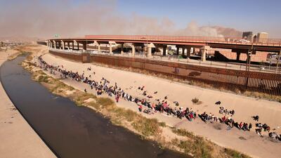 Migrants, among them Nicaraguans who were kidnapped and released days later, queue near the US-Mexico border to request asylum. Reuters