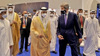 Sheikh Mansour bin Zayed, Deputy Prime Minister and Minister of Presidential Affairs, tours with John Kerry, the US president's climate envoy, the Global Manufacturing and Industrialisation (GMIS) Summit in Dubai on November 22, 2021. AFP