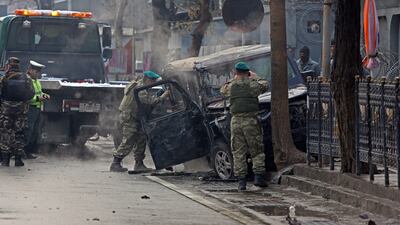 Turkish soldiers inspect a damaged vehicle at the site of a suicide attack in Kabul on February 26. Rahmat Gul / AP Photo