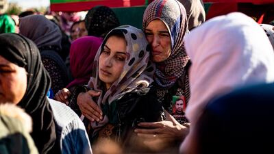 Relatives mourn at a funeral for two Syrian Democratic Forces (SDF) fighters in the Syrian Kurdish-majority city of Qamishli, after they were killed by a Turkish military drone, according to Kurdish security officials. AFP