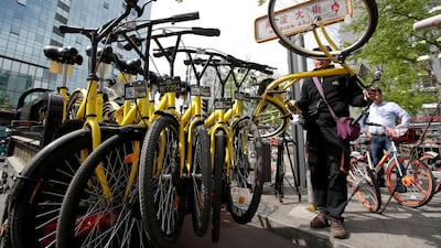 A staff member from the bike-sharing company Ofo gathers its shared bikes for use during the evening rush hour, in Beijing, China. Jason Lee/Reuters