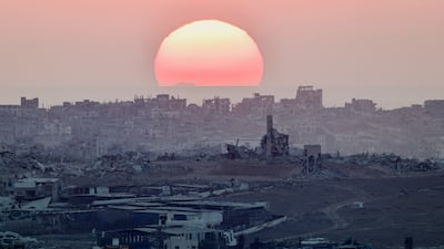 The sun sets behind the desolate landscape in northern Gaza, after almost 22 months of Israeli strikes. Reuters