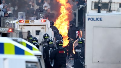 Protesters and police near a hotel previously believed to house migrants. AFP