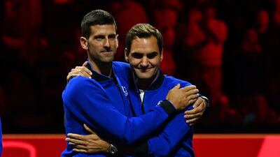 Novak Djokovic embraces Switzerland's Roger Federer at the presentation ceremony. AFP