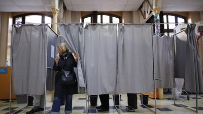 Polls suggest far-right nationalist Marine Le Pen and Emmanuel Macron, an independent centrist and former economy minister, were in the lead. Seen here is a woman coming out of a voting booth at a polling station in Pantin, north-east of Paris. Benjamin Cremel/AFP