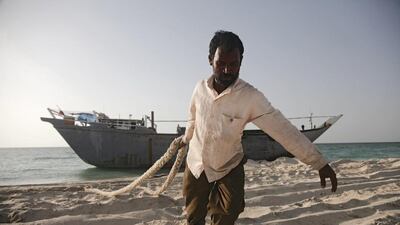 Seen here is Saidu, pulling rope that was cut off the boat onto a car. Lee Hoagland / The National