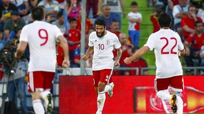 Georgia's Tornike Okriashvili, centre, celebrates with his teammates after scoring the only goal against Spain. Emilio Naranjo / EPA