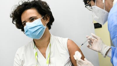 Head of the ASST Cremona vaccination Department, Antonella Laiolo, administers the Pfizer/BioNTech COVID-19 vaccine to a worker of the Cremona hospital in Cremona, Italy. Reuters