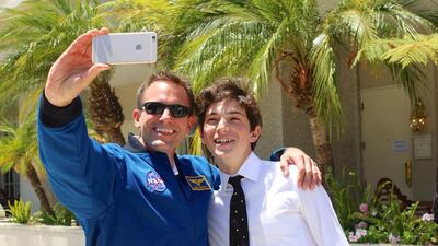 Julian Rubinfien, 16, winner of Genes in Space’s US version, met the Nasa astronaut Josh Cassada Courtesy Julian Rubinfien