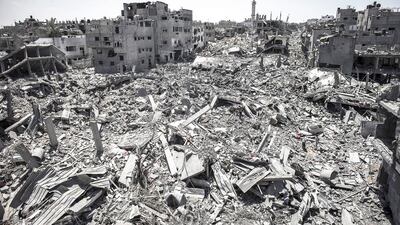 Destroyed buildings after Israeli attacks in a part of the Shuja'iyya neighbourhood in east Gaza City on Saturday. Dozens of Palestinian bodies were recovered from rubble in the Gaza Strip, medics said, in the middle of a 12-hour humanitarian ceasefire. EPA/OLIVER WEIKEN