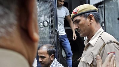 Mukesh Singh, centre, and Vinay Sharma, two of the four men sentenced to death for raping and torturing a young woman on a moving bus in New Delhi, arrive at the Delhi High Court today as appeals against their sentence and verdict begins. Tsering Topgyal / AP Photo