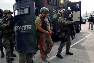 Colombian drug lord and head of the Gulf Clan Dairo Antonio Usuga is escorted by Colombian police on May 4, 2022. AFP