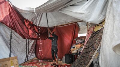 Makeshift tents offer little protection from heavy rain. Getty Images