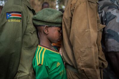 Former child soldiers wait in line in the war-torn region of Yambio, South Sudan, during a graduation ceremony from a programme that aims to help them reintegrate into society. AFP