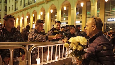 A Lebanese protester gives flowers to security forces during ongoing anti-government demonstrations in the capital Beirut. AFP