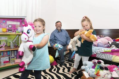 Denzil Coulson with his daughters Aliza and Ilana. Reem Mohammed / The National
