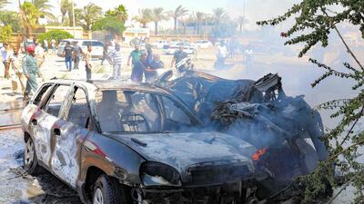 Libyans gather at the site of a car bomb attack in Libya's eastern city of Benghazi that killed three members of the UN mission. AFP