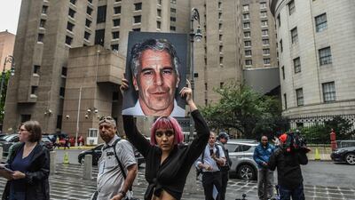 A member of a protest group holds up a sign of Jeffrey Epstein in New York City in 2019. AFP