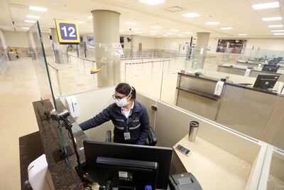 A woman works at the migration area at Mariscal Sucre Airport in Quito, Ecuador. Getty
