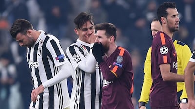 Paulo Dybala, second from left, speaks to fellow Argentine forward Lionel Messi after both players had contrasting games. Filippo Monteforte / AFP
