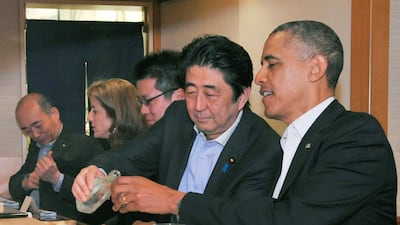 Japanese Prime Minister Shinzo Abe pours sake for US President Barack Obama as they have dinner at the Sukiyabashi Jiro sushi restaurant in Tokyo. Reuters