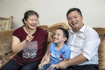 Can Cai, his mother, Ying Luo, and five-year-old son, Tiancheng Cai, at home in Dubai. Antonie Robertson / The National