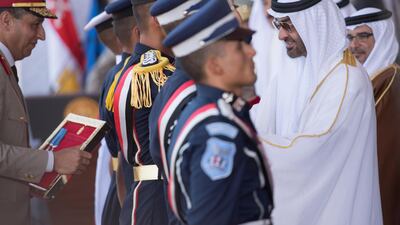 Sheikh Mohammed bin Zayed Al Nahyan, Crown Prince of Abu Dhabi and Deputy Supreme Commander of the UAE Armed Forces, presents a medal to graduating students of the Egyptian Armed Forces military colleges, during the inauguration of the Mohamed Naguib Military Base. Rashed Al Mansoori.