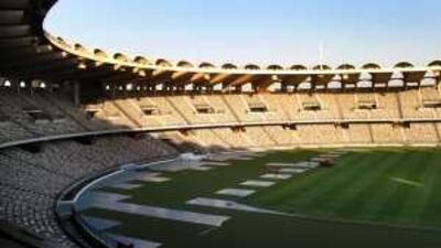 Workers renovate the pitch at Zayed Sports City. The pitch was tested at the game between Manchester City and the UAE last month.