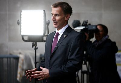 Chancellor of the Exchequer Jeremy Hunt talks to a television crew outside the BBC's headquarters in London. Reuters