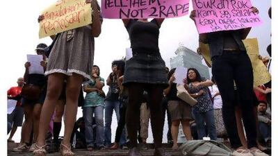 Women in Jakarta wearing miniskirts and tight leggings hold posters to protest against the idea that provocatively dressed women are to blame for sexual assaults. REUTERS / Stringer