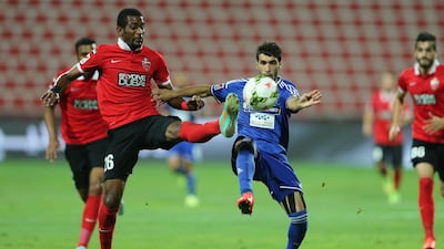 Al Ahli’s Abdulaziz Hussain, left, vies for possession against Al Nasr during Thursday night’s match in Dubai. Ashraf Umrah / Al Ittihad