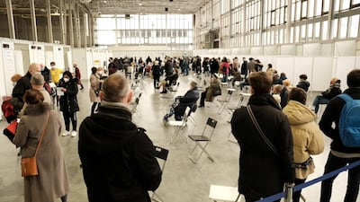 People wait to receive the coronavirus vaccine at a temporary vaccination centre at the International Fair in Poznan, Poland. Reuters