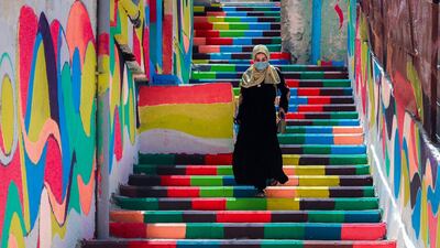 A Palestinian woman walks down brightly coloured steps in the old Al-Daraj neighbourhood of Gaza city. AFP