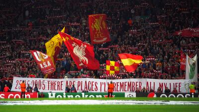 Liverpool fans in the stands show their support at Anfield.