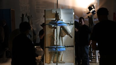 A Terracotta Warrior statue, wrapped in protective foam, is moved into place in the Reading Room in 2007