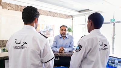 Security staff at work in the UAE. Companies that insist employees work excess hours are breaking the law. Photo: Reem Mohammed / The National
