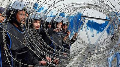 Riot police on guard outside Egypt's parliament in Cairo on January 23 for the first session since elections.