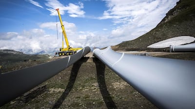 A crane at Griessee lake. The wind turbine blades are 45 metres in length and weigh about 11,000 kilograms. Olivier Maire / EPA