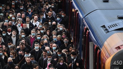 Masked and unmasked commuters mingle at Waterloo Station in London on Thursday morning. England's Covid-19 regulations are due to end on 24 February. EPA