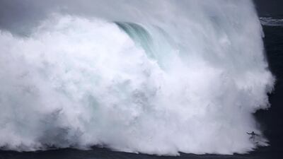 A surfer drops in on a large wave at Praia do Norte in Nazare, Portugal. Rafael Marchante / Reuters