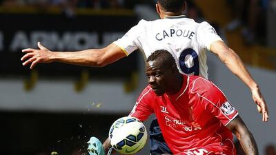 Liverpool's Mario Balotelli wins the ball from Tottenham Hotspur's Etienne Capoue during their Premier League match on Sunday. Eddie Keogh / Reuters