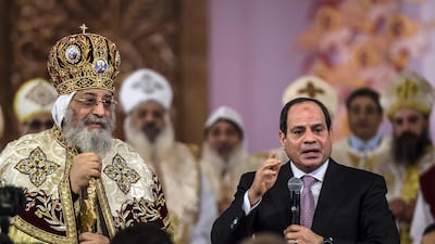 Egyptian president Abdel Fattah El Sisi speaks during a Christmas Eve mass as Coptic Pope Tawadros II looks on at the new Nativity of Christ Cathedral in Egypt's new administrative capital near Cairo on January 6, 2018. Khaled Desouki / AFP